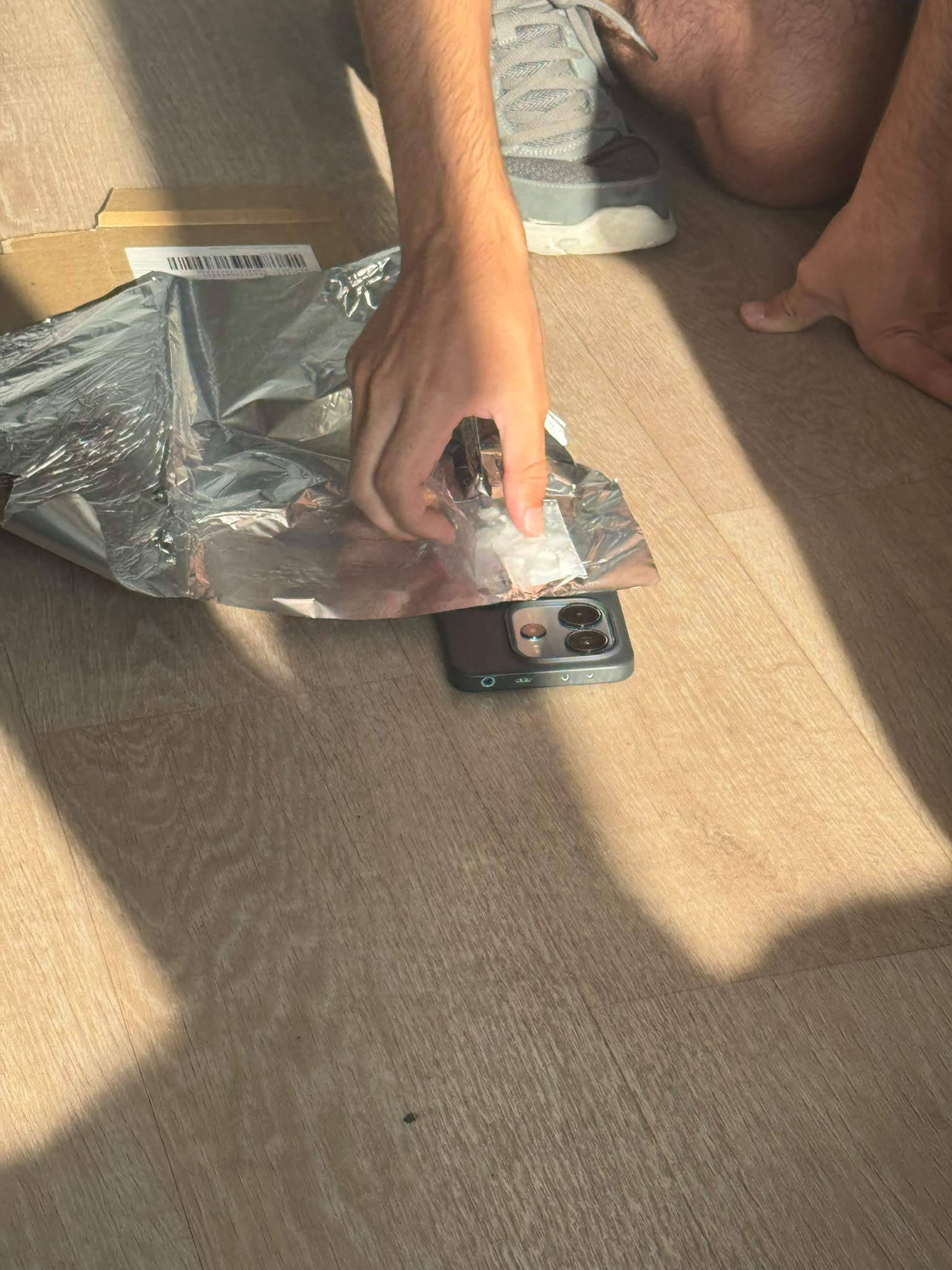 Fitting a prototype cooling pouch to the back of a phone